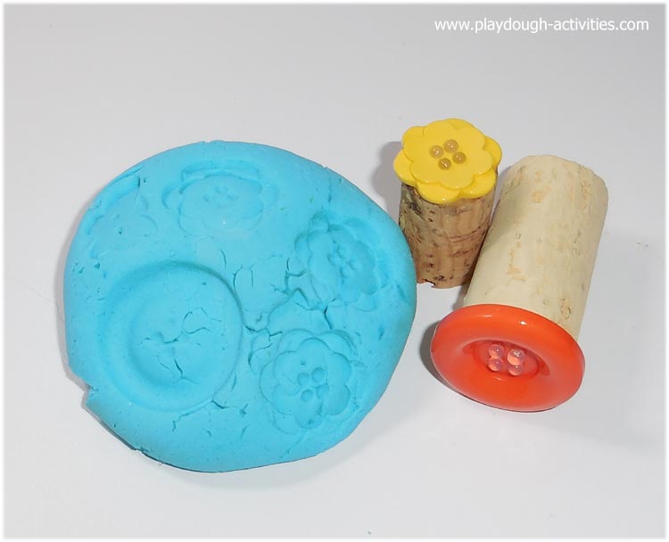 Playdough stamps made from buttons and corks