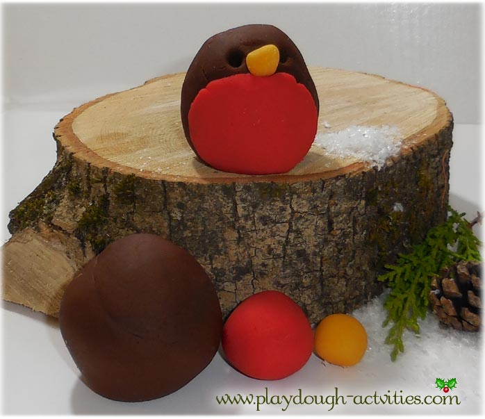 Rolling balls of playdough to make Christmas robins