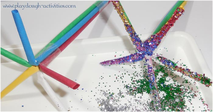 Dip sticky taped art straws in glue then glitter to make crackling firework sparklers