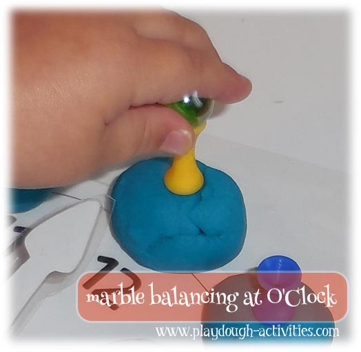 Practice pincer grip skills by balancing marbles on blunt golf tees