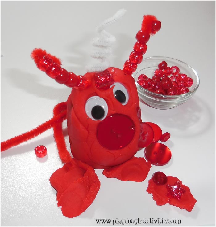 build coloured playdough monsters with eyes, stems and other collage pieces
