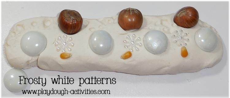 Build patterns in the surface of snowy white play dough