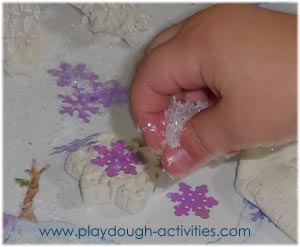 Fine motor skills - pinching and sprinkling artificial snow
