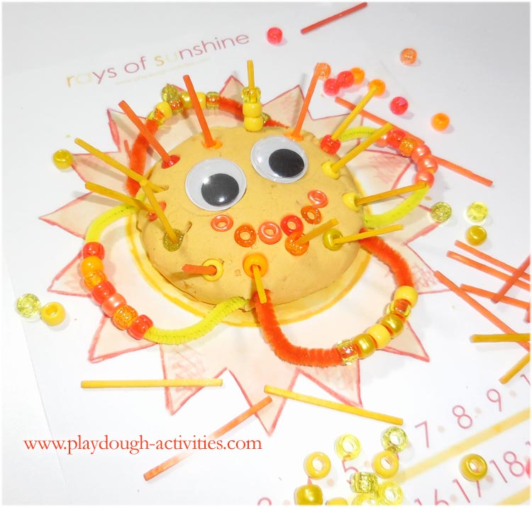 Sunny face playdough bead threading activity idea
