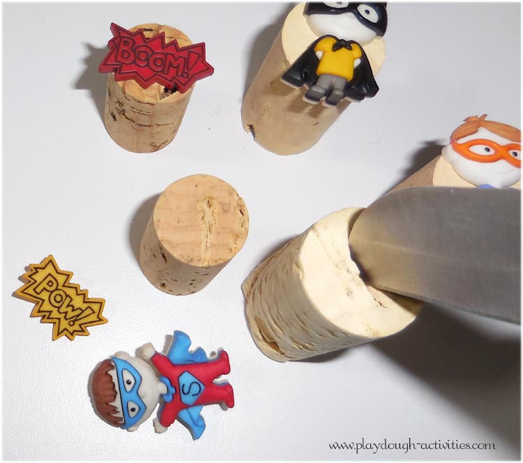 press a groove into the top of the cork to fit the back of the button in place