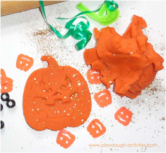Halloween Jack O Lantern faces made from orange pumpkin playdough